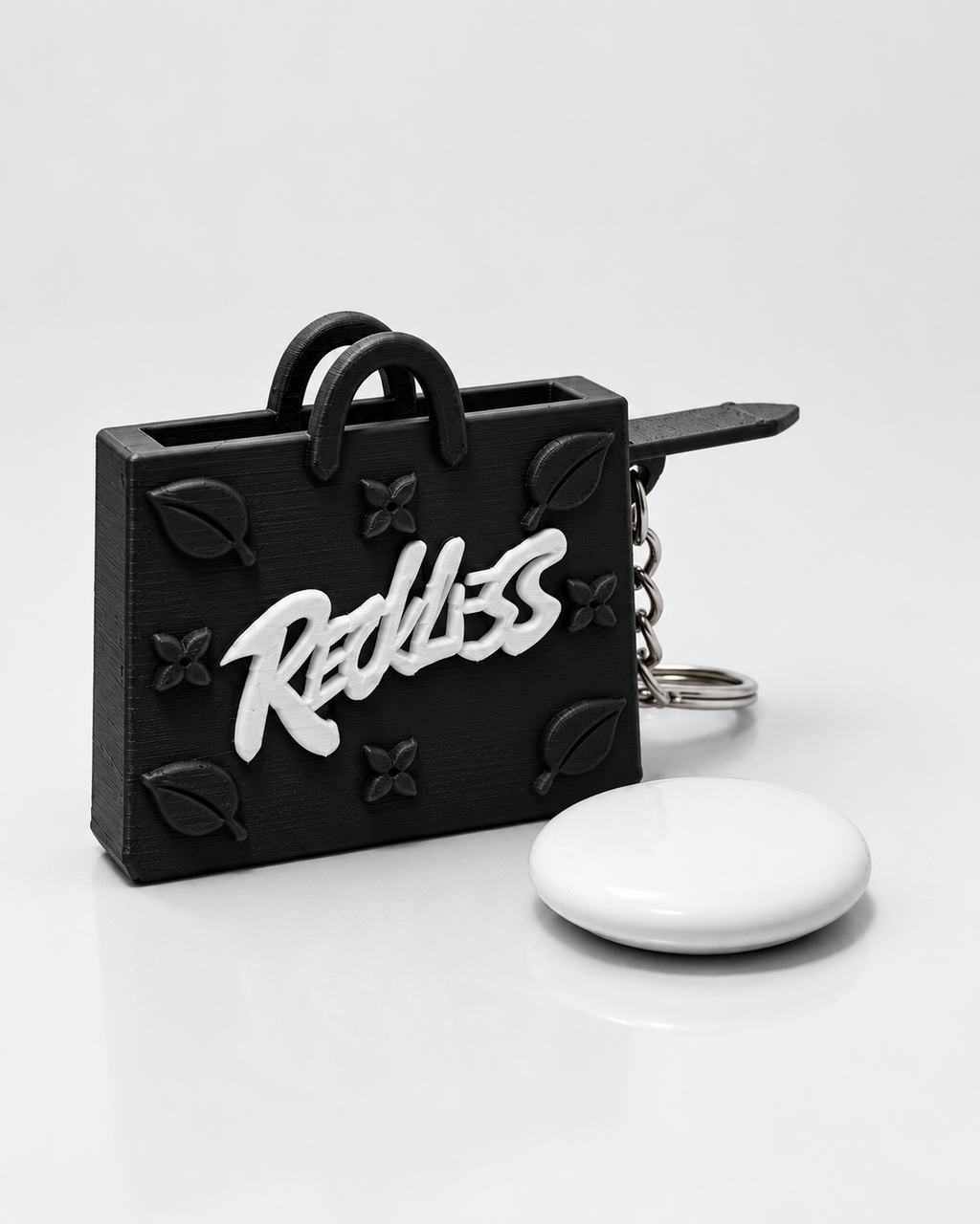 InKeynito Chain AirTag holder keychain - Black and white limited edition, front view with AirTag