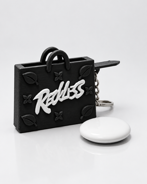 InKeynito Chain AirTag holder keychain - Black and white limited edition, front view with AirTag