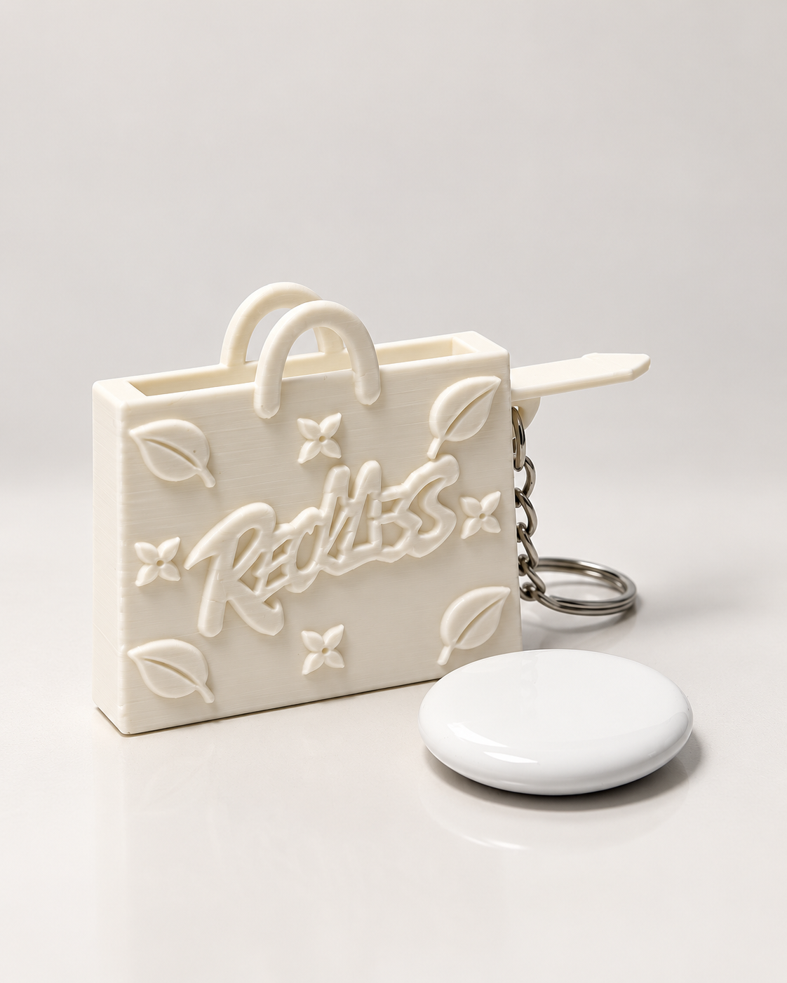 InKeynito Chain AirTag holder keychain - White, front view with AirTag