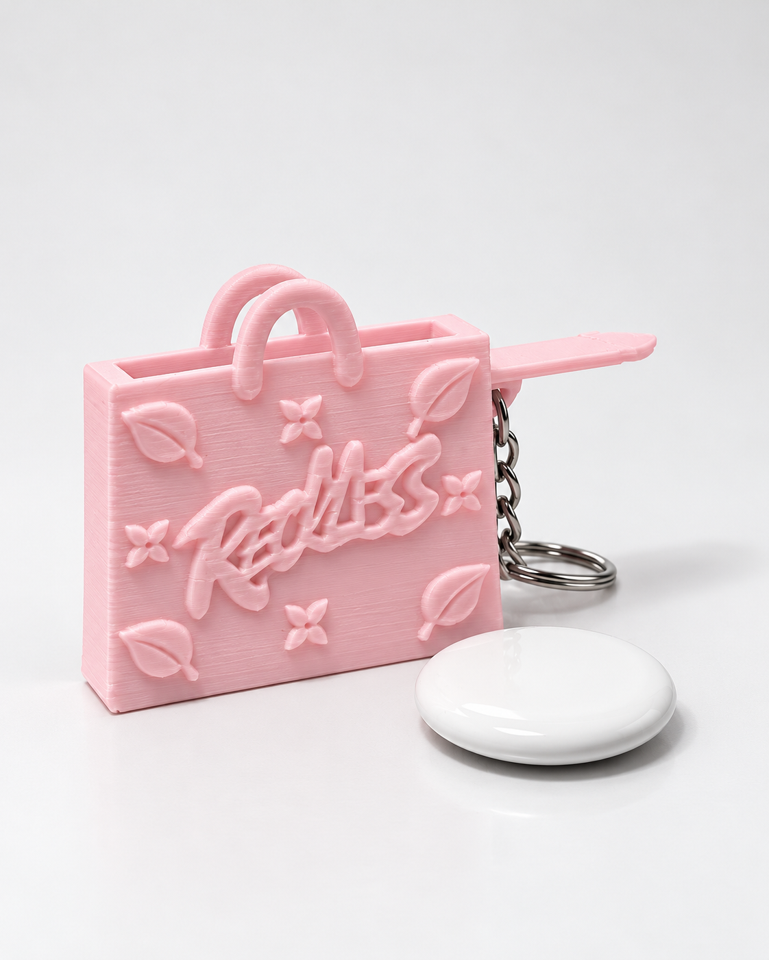 InKeynito Chain AirTag holder keychain - Pastel Pink, front view with AirTag